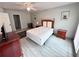 This bedroom features neutral walls, a ceiling fan, and wood-look flooring at 3750 Clubhouse Se Ln, Conyers, GA 30094