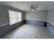 Neutral bedroom features fresh gray paint, white trim, and a large window for natural light at 3750 Clubhouse Se Ln, Conyers, GA 30094