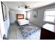 This bedroom features neutral walls, light wood-look flooring, and two windows at 3750 Clubhouse Se Ln, Conyers, GA 30094