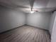 Bedroom area, featuring light gray floors, neutral walls, and a ceiling fan at 3750 Clubhouse Se Ln, Conyers, GA 30094