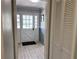 This entryway features a white door with glass, wood-look flooring, and closet at 3750 Clubhouse Se Ln, Conyers, GA 30094