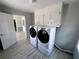 Laundry room featuring modern washer and dryer with convenient storage cabinets above at 3750 Clubhouse Se Ln, Conyers, GA 30094