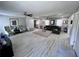 Open-concept living room with a neutral color scheme, wood flooring, and contemporary furnishings at 3750 Clubhouse Se Ln, Conyers, GA 30094