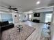 Spacious living room with light gray walls, wood floors, ceiling fans and ample natural light at 3750 Clubhouse Se Ln, Conyers, GA 30094