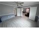 Spacious living room features a ceiling fan, neutral paint, and light, wood-look flooring at 3750 Clubhouse Se Ln, Conyers, GA 30094