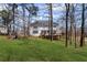 Expansive backyard view showcasing the home's exterior, deck, and fire pit area at 4140 Hillsborough, Cumming, GA 30041