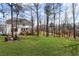 Expansive backyard featuring a deck, fire pit, and lush green lawn, perfect for outdoor entertaining and relaxation at 4140 Hillsborough, Cumming, GA 30041