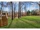 Lush backyard with mature trees, a well-maintained lawn, and stone borders at 4140 Hillsborough, Cumming, GA 30041