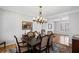 This dining room features hardwood floors, a beautiful chandelier, and seating for eight along with lots of natural light at 4140 Hillsborough, Cumming, GA 30041