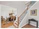 Elegant foyer with a staircase, hardwood floors, and a dining room view, offering a warm and inviting atmosphere at 4140 Hillsborough, Cumming, GA 30041