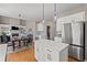 This open-concept kitchen/dining/living space features hardwood floors, white cabinets, and modern decor at 4140 Hillsborough, Cumming, GA 30041