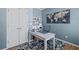 This home office features blue walls, white trim, and a beautiful decor with a map and other interesting artwork at 4140 Hillsborough, Cumming, GA 30041