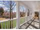 Spacious porch with white columns and railings, offering a peaceful outdoor seating area with a scenic view at 4140 Hillsborough, Cumming, GA 30041