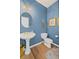 Powder room with a pedestal sink and blue paint at 4140 Hillsborough, Cumming, GA 30041