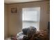 Messy bedroom with a large window and natural light at 53 Oakview Dr, Carrollton, GA 30116