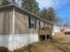 Exterior side view of a single Gathering home on a tree-filled lot at 53 Oakview Dr, Carrollton, GA 30116