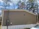 Side view of a tan home, showing the siding and utility connections at 53 Oakview Dr, Carrollton, GA 30116