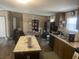 Open kitchen featuring a breakfast bar, dark appliances, laminate floors, and plenty of natural light at 53 Oakview Dr, Carrollton, GA 30116