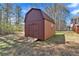 Storage shed with double doors sitting in a large backyard at 539 Villa Rosa Rd, Temple, GA 30179