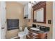 Bathroom featuring a wood vanity with a black marble countertop and classic design at 539 Villa Rosa Rd, Temple, GA 30179