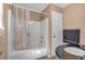 Bathroom featuring a tub and shower combo with a clear shower curtain at 539 Villa Rosa Rd, Temple, GA 30179