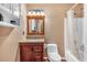 This bathroom boasts a combined shower-tub with neutral tones and a well-lit vanity at 539 Villa Rosa Rd, Temple, GA 30179