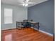 Bright bedroom featuring a large desk, ceiling fan, and wood flooring at 539 Villa Rosa Rd, Temple, GA 30179