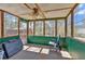 Relaxing sunroom enclosed with large windows and a ceiling fan at 539 Villa Rosa Rd, Temple, GA 30179