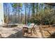 Patio area with dining table, trampoline, and partially wooded backyard at 959 Hampton Nw Trl, Lilburn, GA 30047