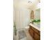 Bathroom with a single sink vanity, decorative mirror and tub with shower at 959 Hampton Nw Trl, Lilburn, GA 30047