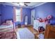 Bright bedroom painted a cool purple, featuring a bed, dresser, and mirror at 959 Hampton Nw Trl, Lilburn, GA 30047