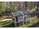 A chicken coop is surrounded by lush greenery and mature trees at 959 Hampton Nw Trl, Lilburn, GA 30047