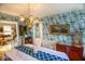 Formal dining room boasts patterned wallpaper, hardwood floors, and classic decor at 959 Hampton Nw Trl, Lilburn, GA 30047