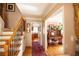 Welcoming foyer features hardwood floors, a staircase with decorative iron railings, and a glimpse into the living spaces at 959 Hampton Nw Trl, Lilburn, GA 30047