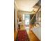 Charming foyer with hardwood floors, decorative rug, staircase with wrought iron, and stylish decor at 959 Hampton Nw Trl, Lilburn, GA 30047
