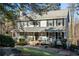 Traditional two-story home with a charming covered front porch and mature trees at 959 Hampton Nw Trl, Lilburn, GA 30047