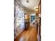 Hallway with hardwood floors, window, and unique artwork leading to the bedroom at 959 Hampton Nw Trl, Lilburn, GA 30047