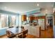 Bright kitchen with wood cabinets, modern appliances, and a table set by the large picture window at 959 Hampton Nw Trl, Lilburn, GA 30047