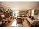 Bright living room featuring a piano, hardwood floors, area rug, and vintage furniture at 959 Hampton Nw Trl, Lilburn, GA 30047
