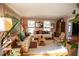 Cozy living room with large tapestry, hardwood floors, area rug, and decorative touches at 959 Hampton Nw Trl, Lilburn, GA 30047