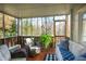 Relaxing screened porch with comfortable seating, a ceiling fan, and wooded views at 959 Hampton Nw Trl, Lilburn, GA 30047