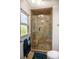 Modern shower with glass door, tiled walls, built-in niche, and comfortable bench at 959 Hampton Nw Trl, Lilburn, GA 30047
