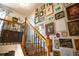 Staircase with wood railing and gallery wall filled with an eclectic collection of art at 959 Hampton Nw Trl, Lilburn, GA 30047