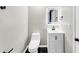 Modern half-bath with black marble floors, bright vanity, and a contemporary, illuminated mirror at 2478 Verbena Nw Cir, Atlanta, GA 30314