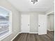 A bedroom with vinyl flooring, a double-hung window and two white doors at 2478 Verbena Nw Cir, Atlanta, GA 30314