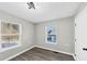A bedroom with vinyl flooring, two double-hung windows and a white door at 2478 Verbena Nw Cir, Atlanta, GA 30314