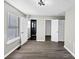 Bright bedroom featuring dark gray vinyl floors and three access doors at 2478 Verbena Nw Cir, Atlanta, GA 30314