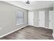 Well-lit bedroom with laminate flooring and neutral walls featuring multiple closets at 2478 Verbena Nw Cir, Atlanta, GA 30314