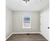 A bedroom with vinyl flooring, a double-hung window and a white door at 2478 Verbena Nw Cir, Atlanta, GA 30314