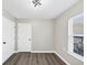A bedroom with vinyl flooring, a double-hung window and two white doors at 2478 Verbena Nw Cir, Atlanta, GA 30314